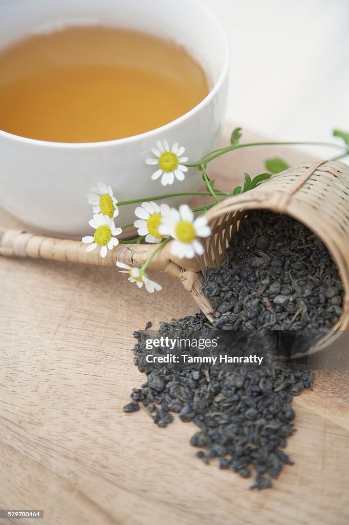 Green tea leaves and chamomile flowers