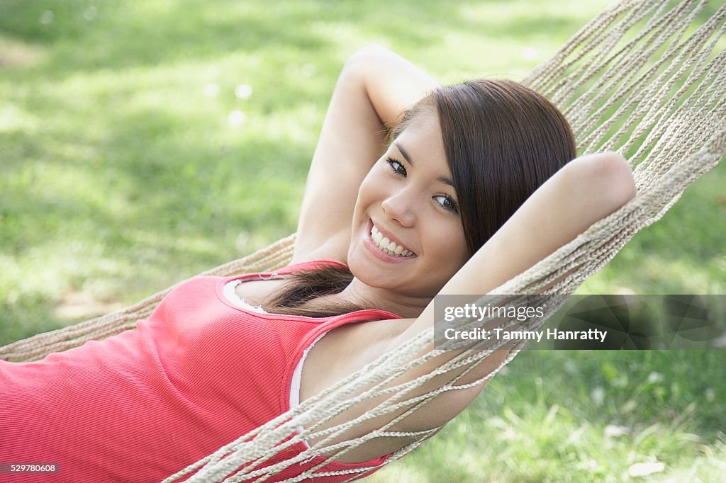 Young woman relaxing in hammock