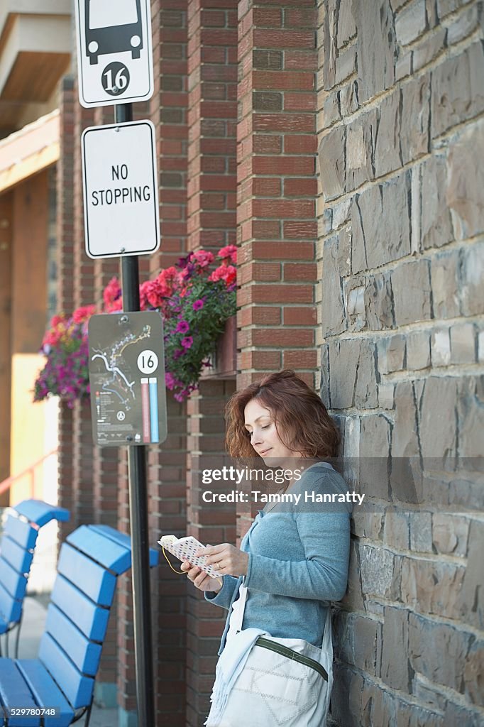 Woman waiting at bus stop