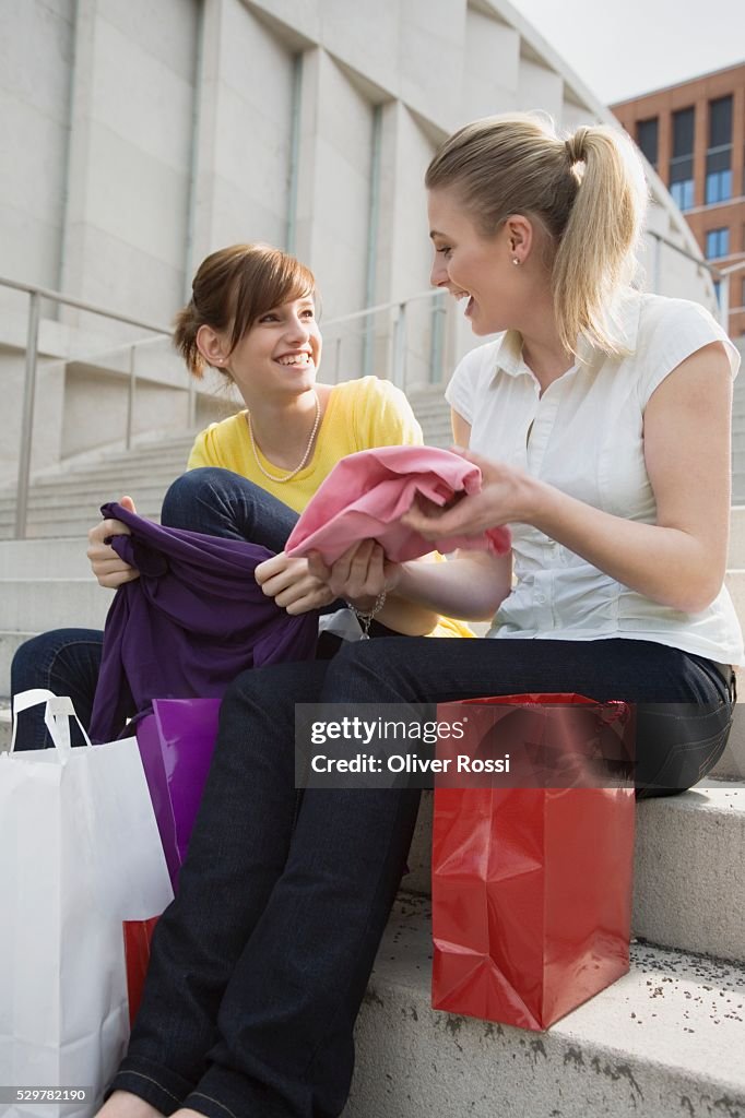 Teen girls on steps of shopping center