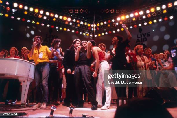British pop acts gathered on stage for the finale of the Live Aid concert at Wembley Stadium in London, 13th July 1985. The group includes George...