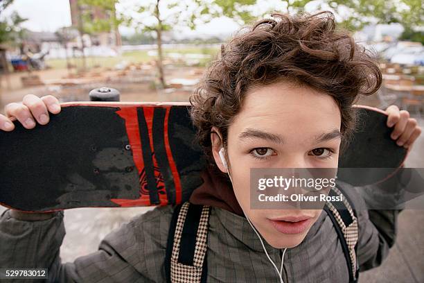 boy carrying skateboard - boy skating stock pictures, royalty-free photos & images