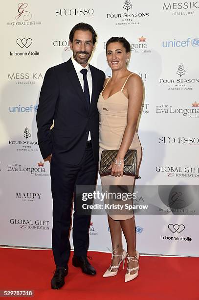 Robert Pires and Jessica Lemarie-Pires attend the Global Gift Gala Photocall at the Hotel Georges V on May 09, 2016 in Paris, France.