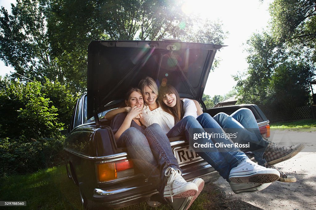 Young friends in the trunk of a car