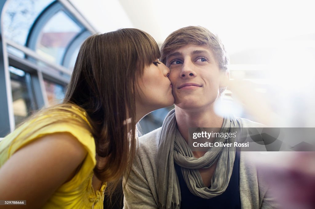 Young woman kissing her boyfriend