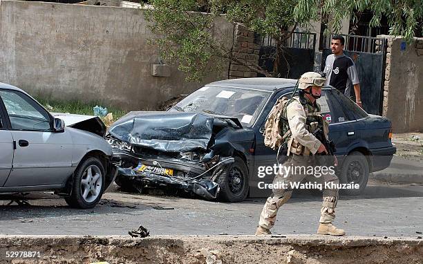 Soldier secures the scene of a suicide car bomb explosion which failed to hit a U.S. Military convoy May 25, 2005 in the area south of Baghdad, Iraq....