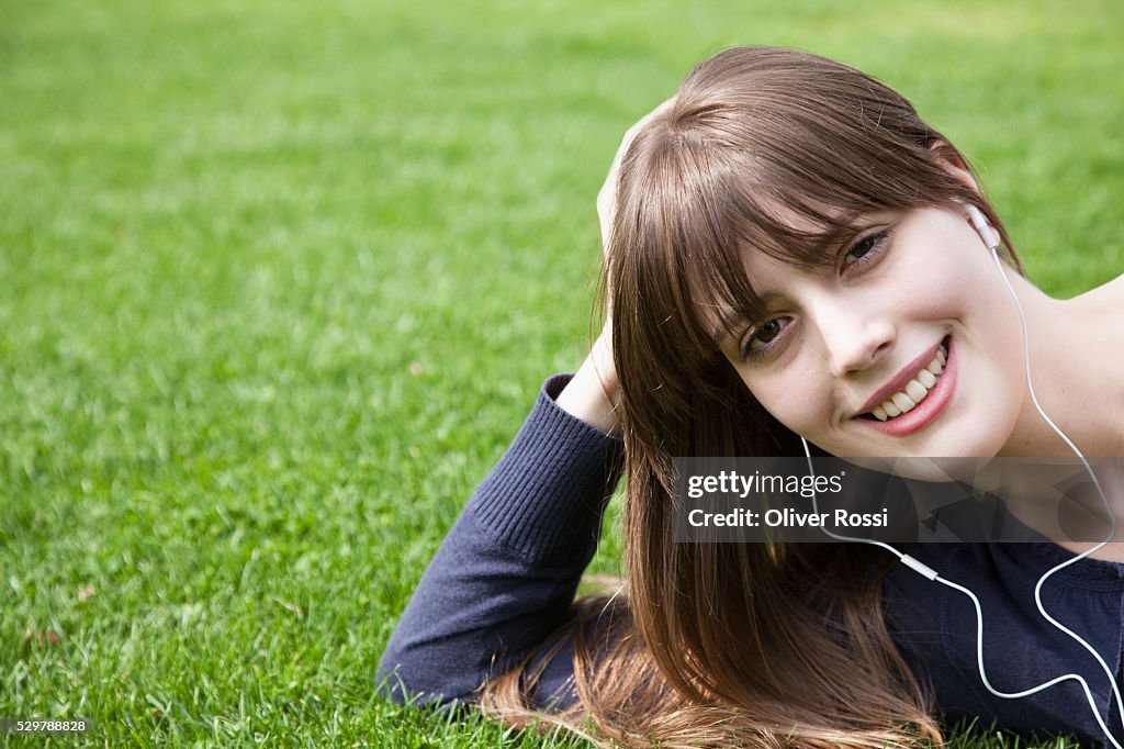 Young woman listening to earbuds