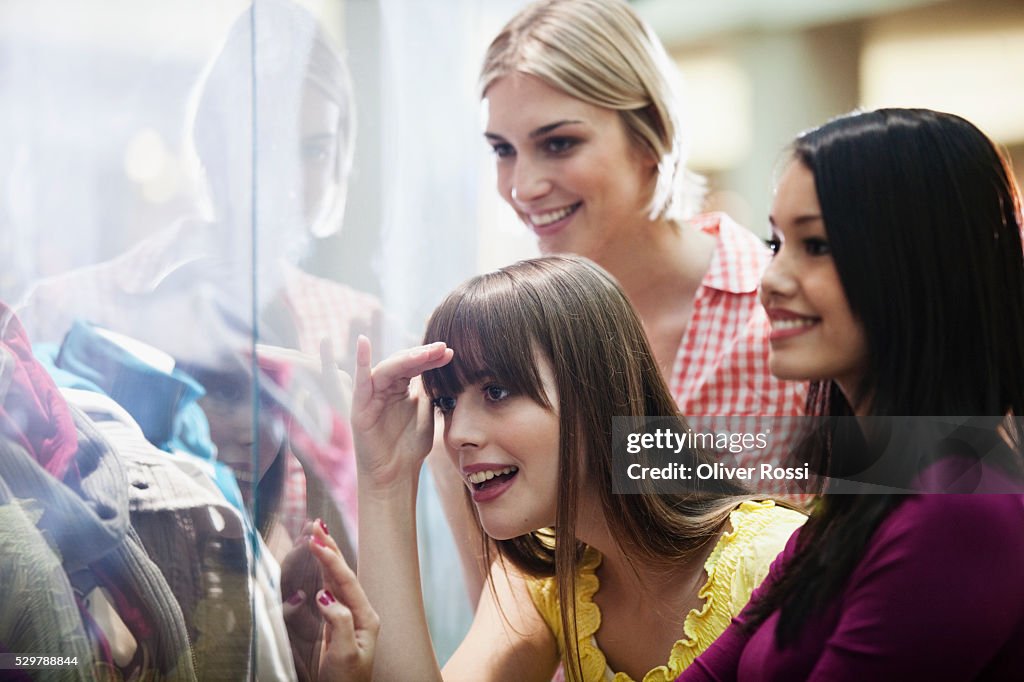 Young friends window shopping