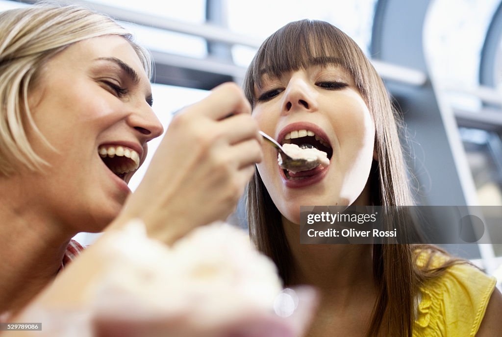 Young friends sharing ice cream