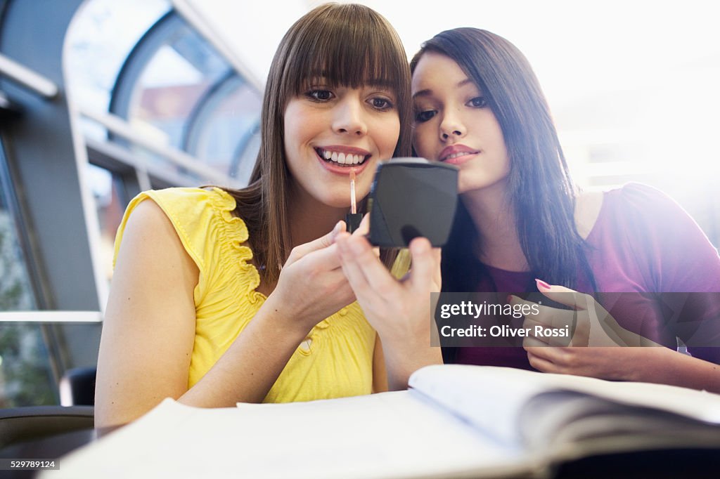 Young friends putting on makeup