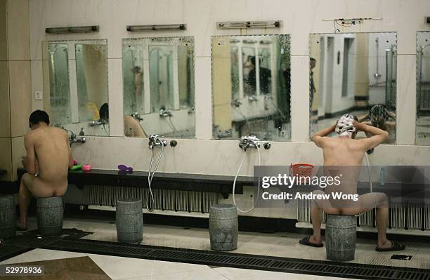 Coal miners wash after their shift at the Number One coal mine of the Huangling Mining Company May 25, 2005 in Huangling County, Shaanxi Province,...