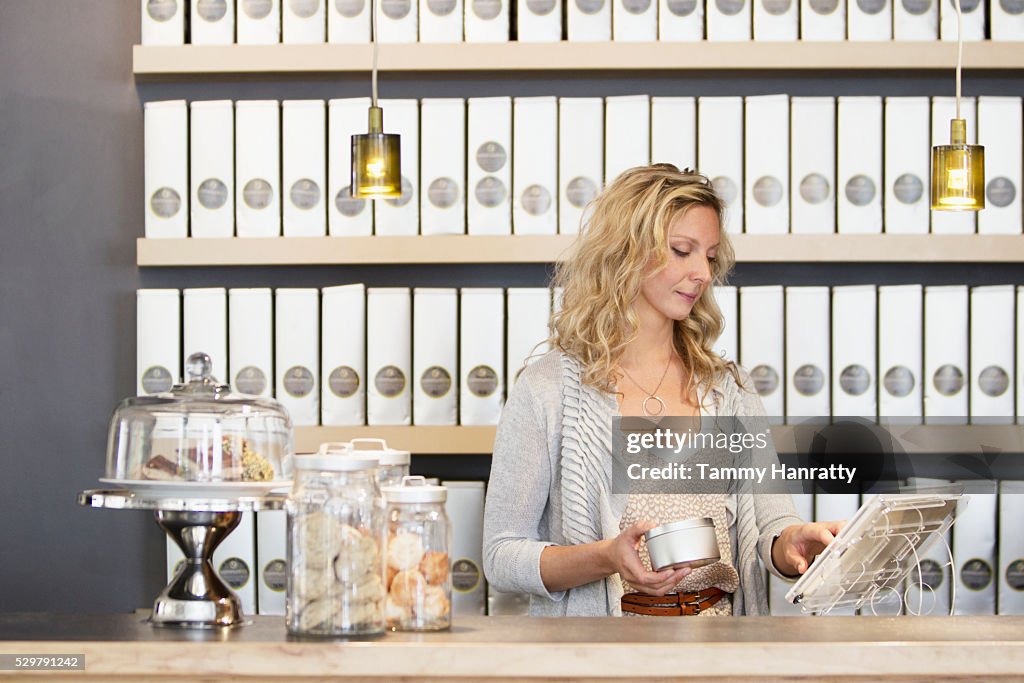 Woman standing behind counter