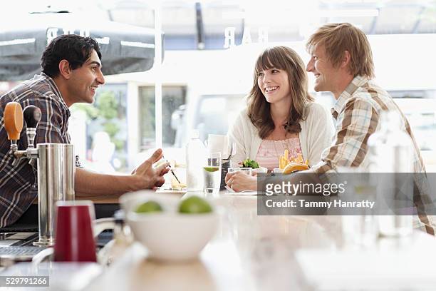 friends talking at bar counter - tammy bar stock pictures, royalty-free photos & images