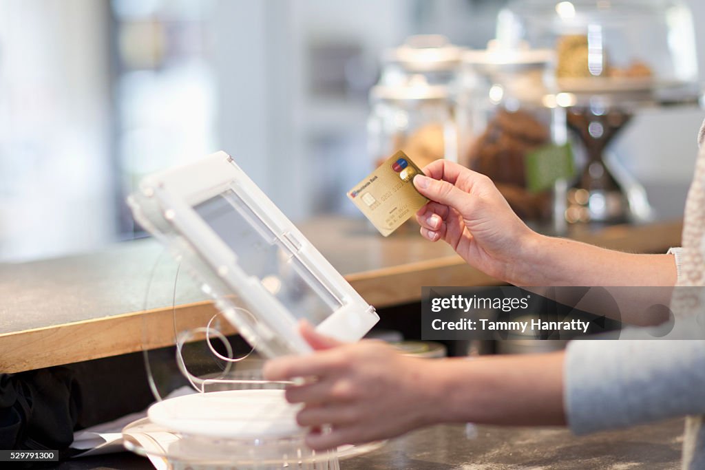 Hand inserting credit card into reader