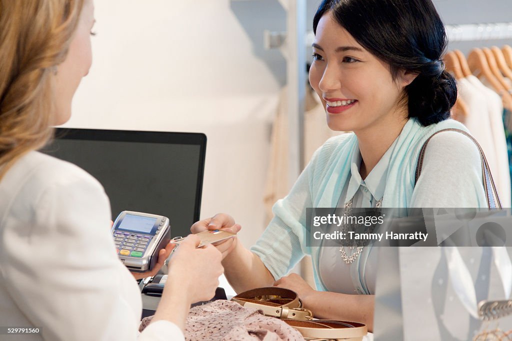 Smiling woman paying with credit card