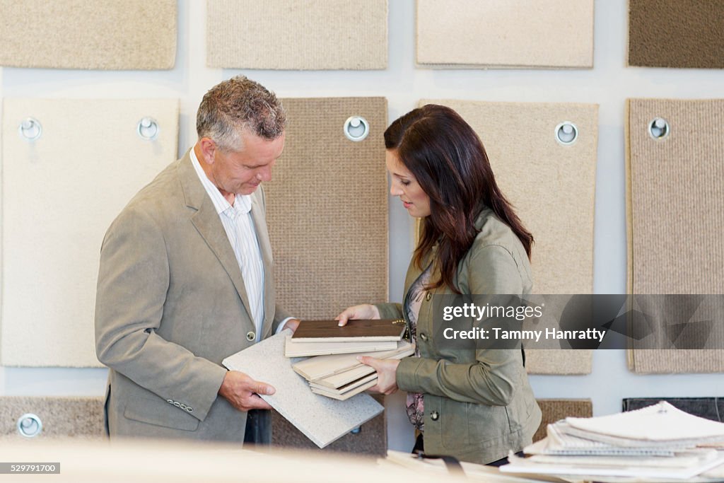 Man and woman looking at textile samples