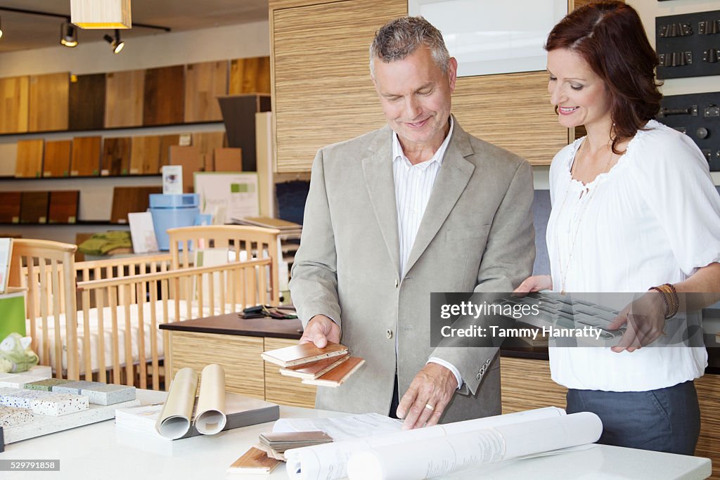 Man and woman looking at blueprints