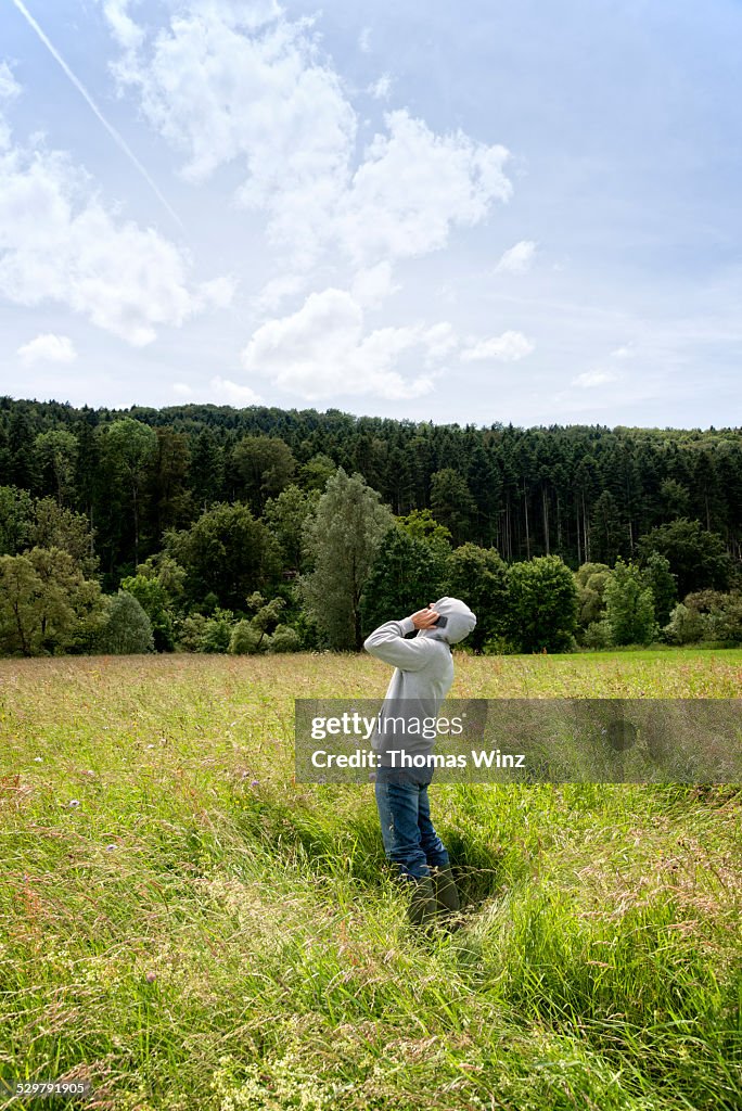 Man on cell phone in a field of grass