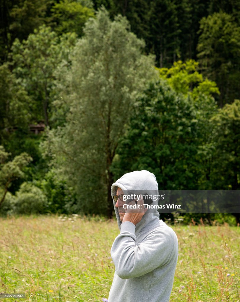 Man on cell phone in a field of grass