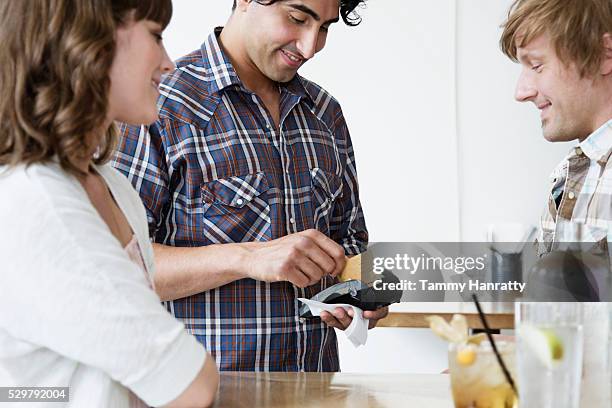 young adults paying bill at bar - tammy bar stock pictures, royalty-free photos & images