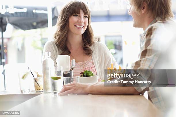 young people chatting in restaurant - tammy bar stock pictures, royalty-free photos & images
