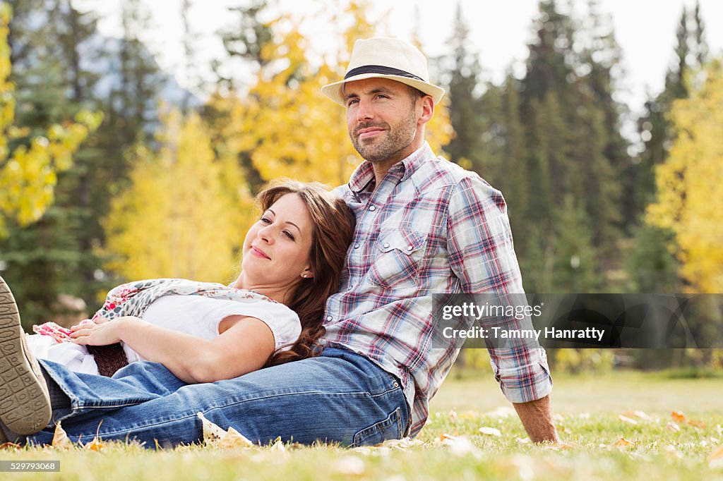 Mid-adult couple relaxing on grass