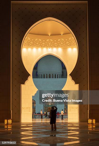 woman photographing a mosque - abu dhabi mosque stock pictures, royalty-free photos & images