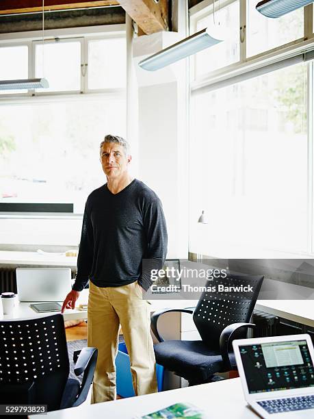 mature businessman in small startup office - one mature man only stock pictures, royalty-free photos & images