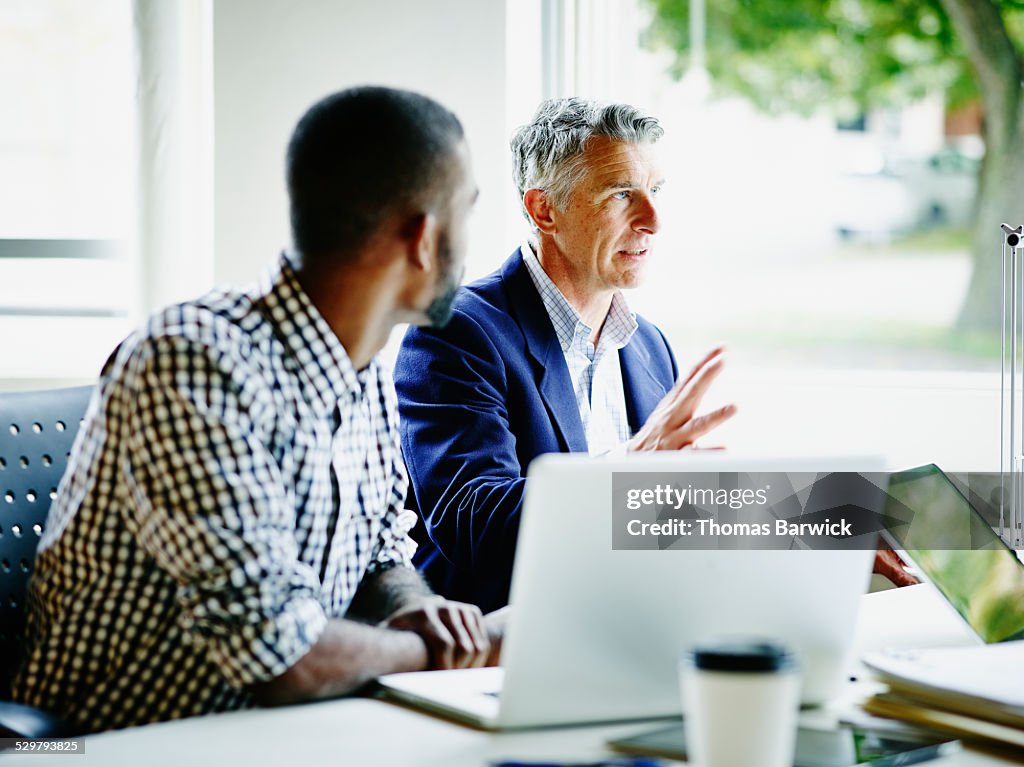 Businessman leading discussion with coworkers