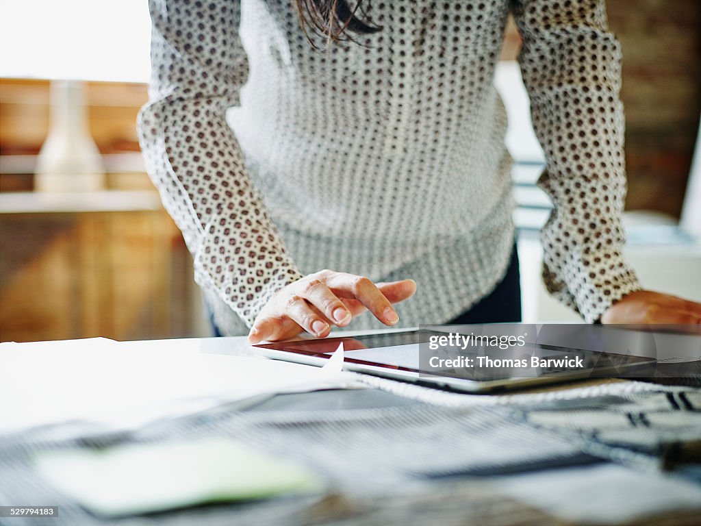 Businesswoman looking at digital tablet in office