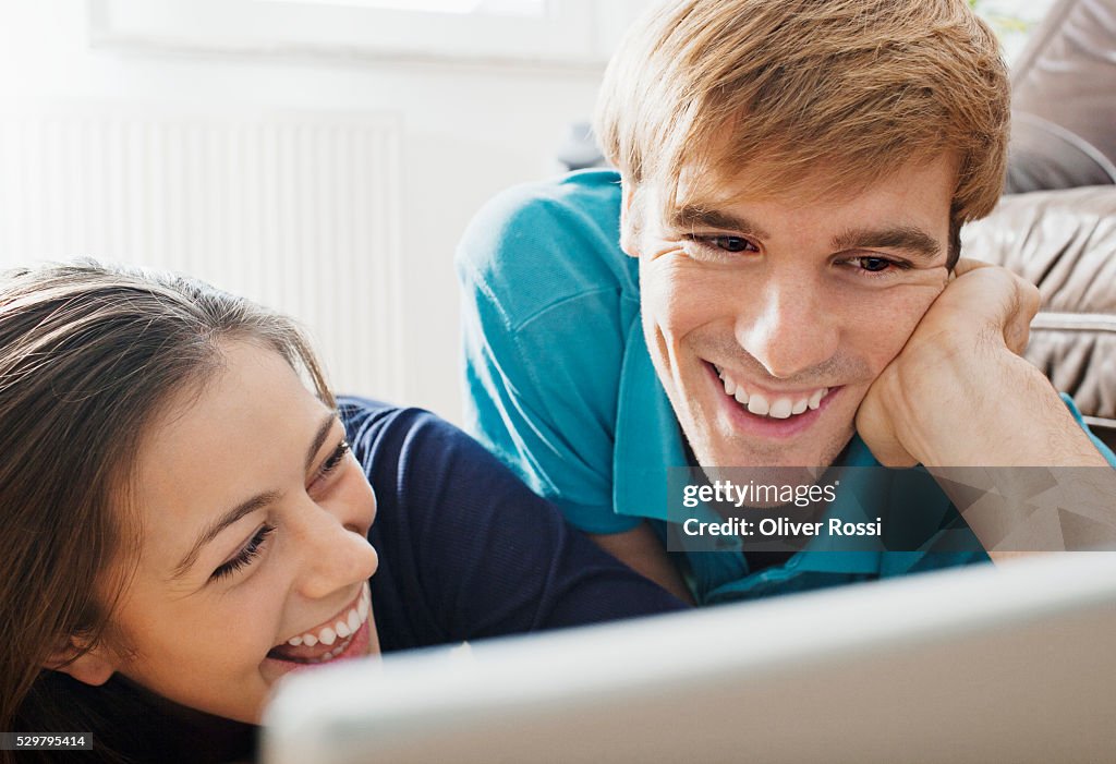 Young couple looking at laptop