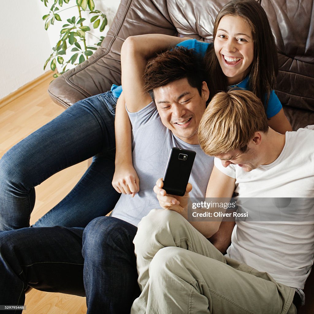 Friends messing about in living room