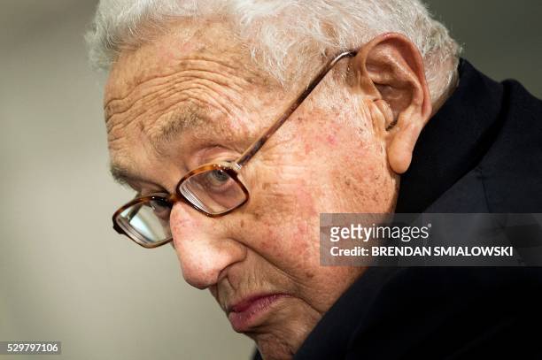 Former US Secretary of State Henry Kissinger listens while he is introduced at a ceremony honoring his diplomatic career on May 9, 2016 at the...