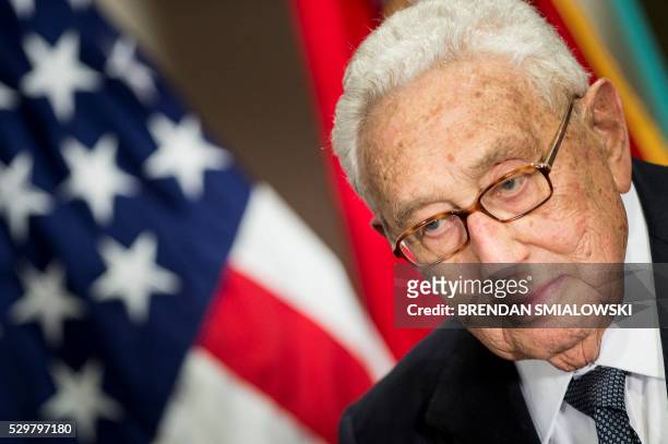 Former US Secretary of State Henry Kissinger listens as he is introduced at a ceremony honoring his diplomatic career on May 9, 2016 at the Pentagon...