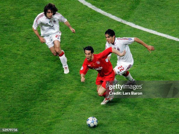 Liverpool forward Luis Garcia of Spain runs for the ball as AC Milan forward Ricardo Kaka of Brazil and AC Milan midfielder Andrea Pirlo chase him...