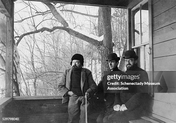 Dr. Charles Steinmetz, John Dempster, and Dr. Willis Whitney sit on the porch of the new GE research laboratory at Steinmetz' farm in Schenectady,...