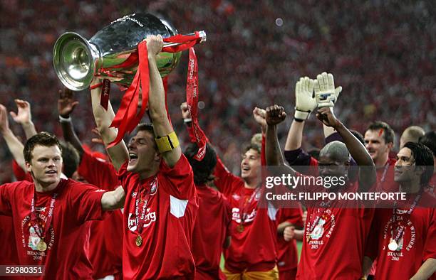 Liverpool's captain Steven Gerrard holds the throphy surrounded by teammates at the end of the UEFA Champions league football final AC Milan vs...