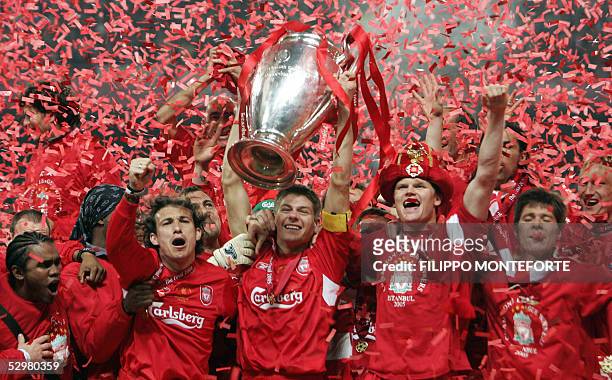 Liverpool's captain Steven Gerrard holds the throphy surrounded by teammates at the end of the UEFA Champions league football final AC Milan vs...