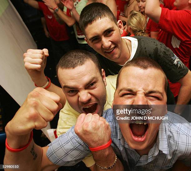 Liverpool fans celebrate in a pub in their home town during the Champions League Final between Liverpool FC and AC Milan after Liverpool scored their...