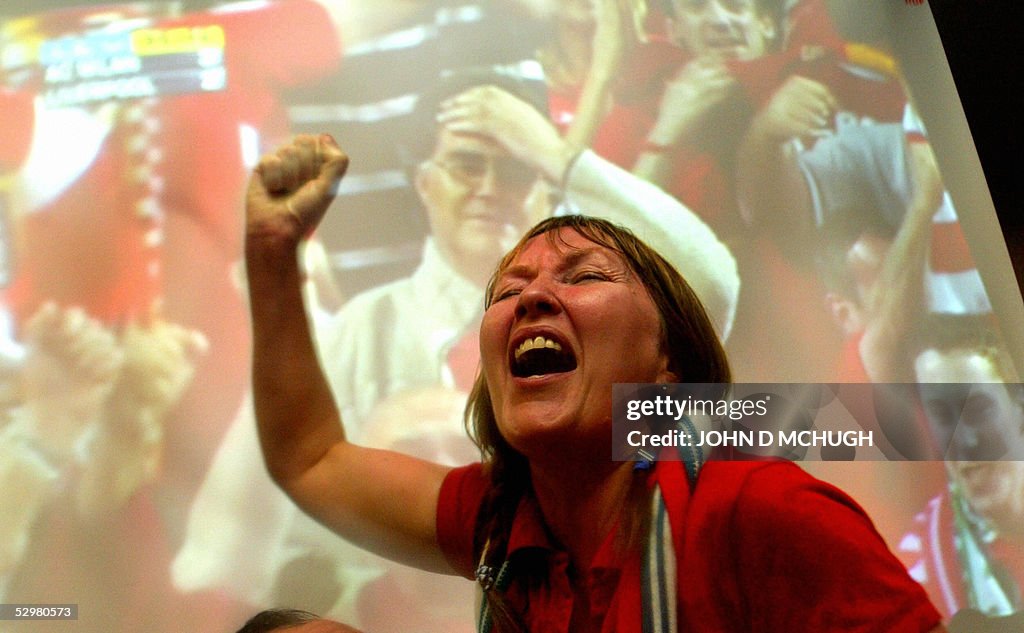 A Liverpool fan celebrates in a pub in L