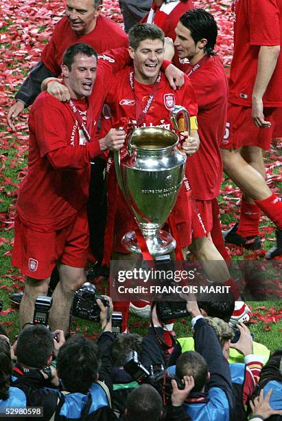 Liverpool players, defender Jamie Carragher, captain and midfielder Steven Gerrard, Liverpool's Spanish midfielder Luis Garcia pose for photographers...