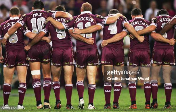 Queensland players sing the national anthem shortly before match one of the ARL State of Origin series between the Queensland Maroons and the New...