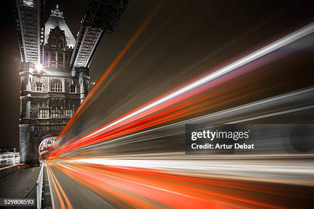 london tower bridge at night with bus lights speed - isolated colour stock pictures, royalty-free photos & images