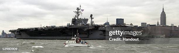 In this handout photo the USS John F. Kennedy is escorted into New York Harbor during the Parade of Ships on May 25, 2005 in New York City. The...