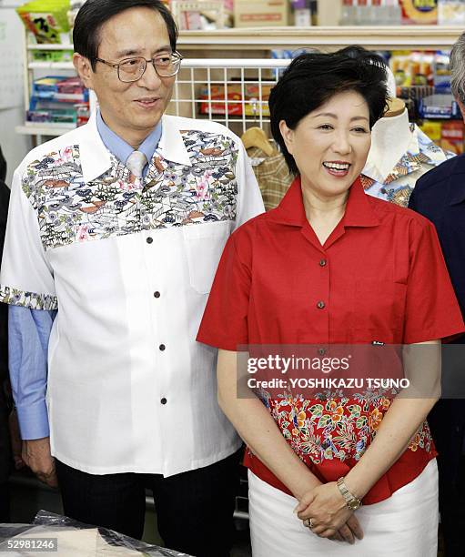 Japanese Chief Cabinet Secretary Hiroyuki Hosoda and Environment Minister Yuriko Koike smile as they wear short sleeve shirts for the promotion...