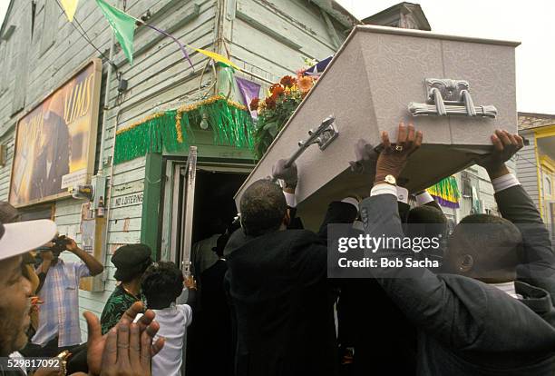 mourners taking casket into bar - pallbearer stock pictures, royalty-free photos & images