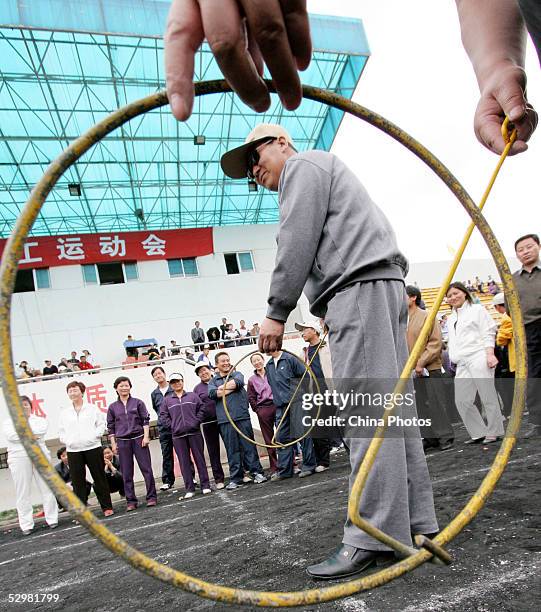 Contestants take their place during a hoop rolling match on May 25, 2005 in Xining of Qinghai Province, China. Hoop rolling is a popular folk sports...