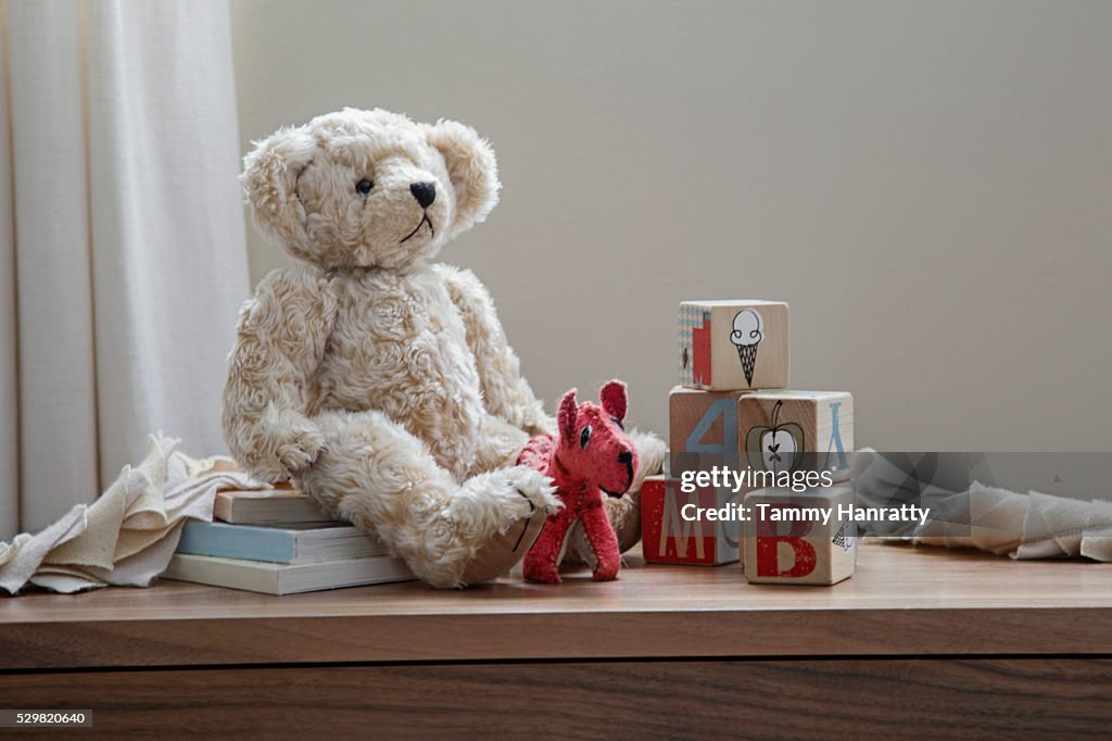 Teddy bear and toys on shelf