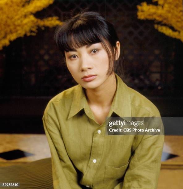 Chinese-born American actress Bai Ling sits and wears a man's green shirt on an episode of the CBS drama 'Touched by an Angel' entitled 'The Spirit...