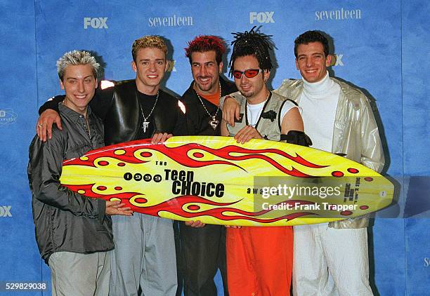 The band 'N'Sync' with their prize: a surfboard.